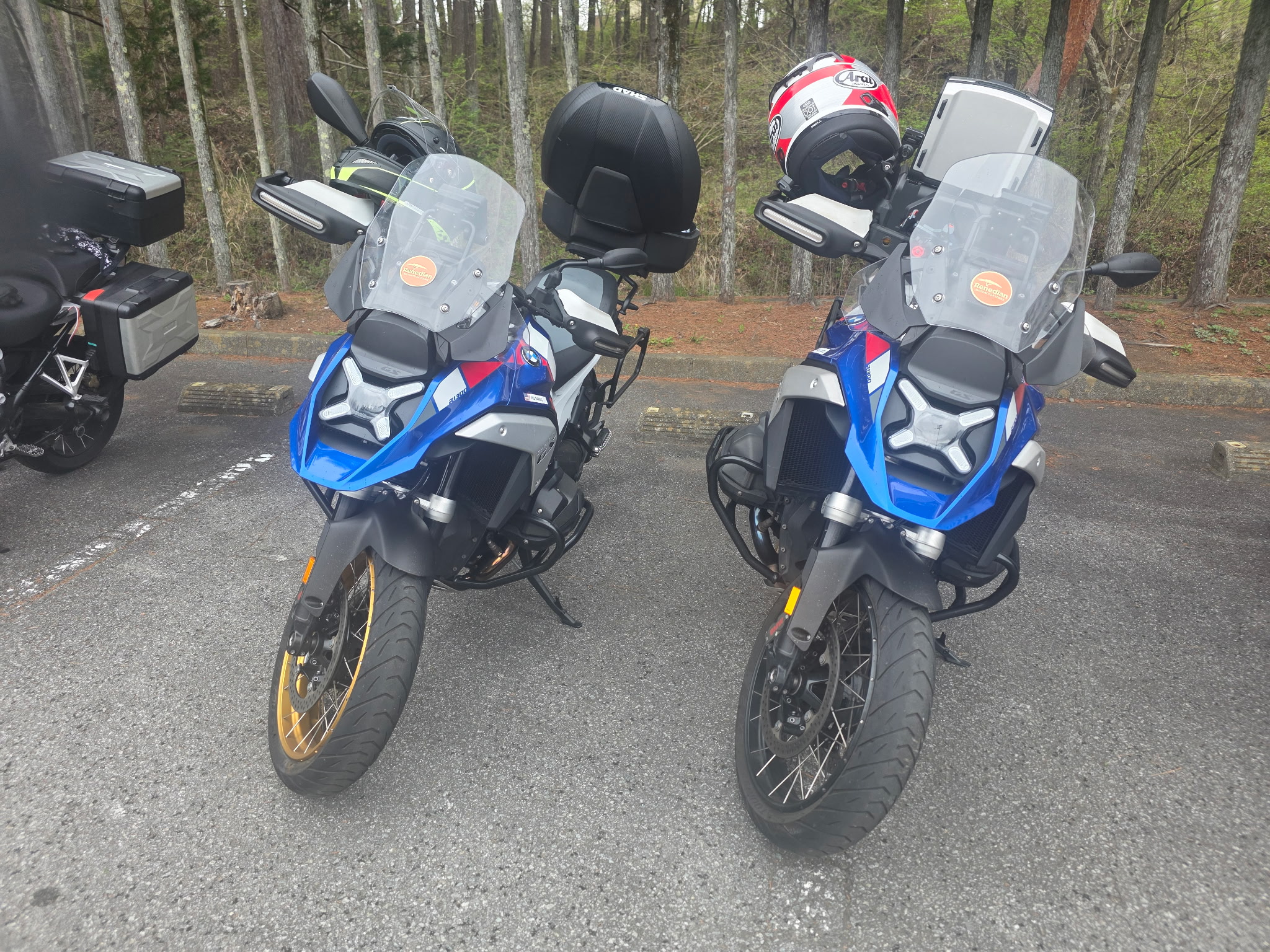 Two adventure bikes parked before a mountain run